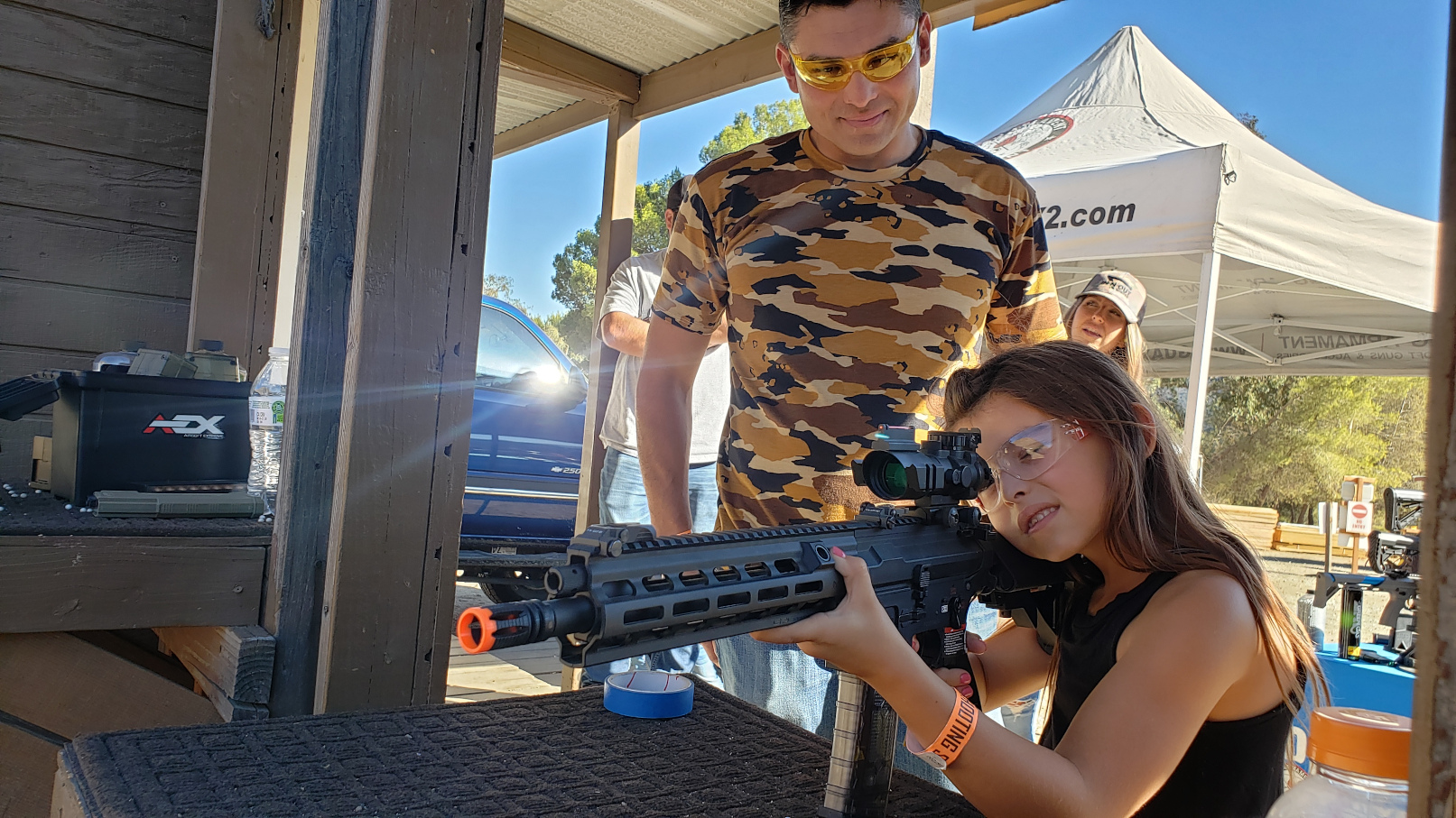 Event goers firing a rifle